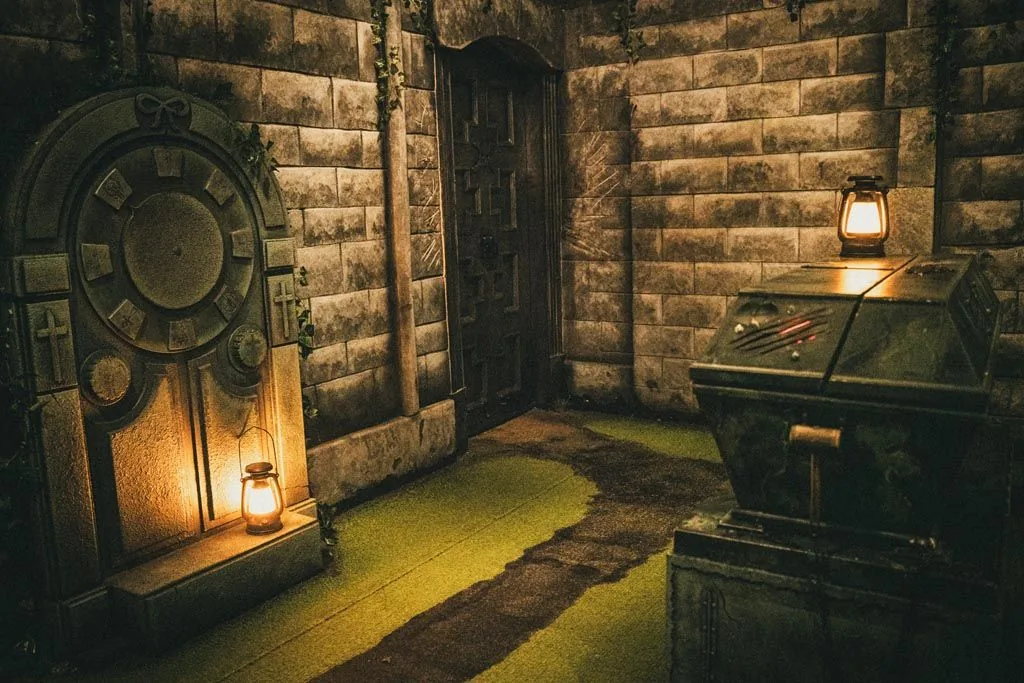 The stone crypt, sarcophagus and carved doors inside the Dracula escape room