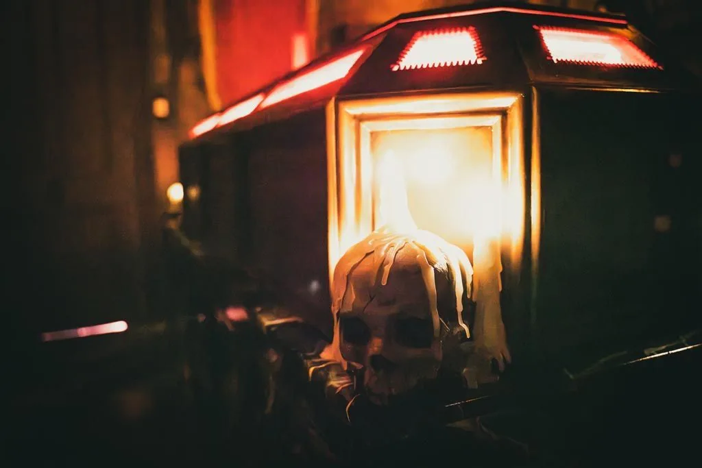 A casket glowing from within, a skull beside it, in the Dracula crypt