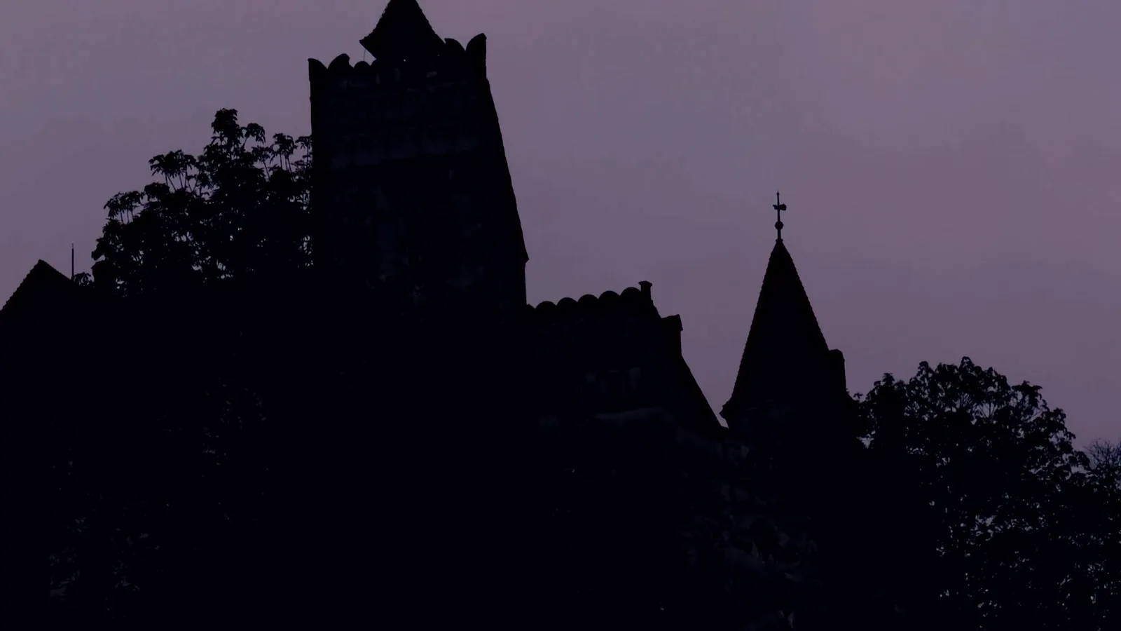 A monastery silhouetted against a violet dusk, from the Dracula film